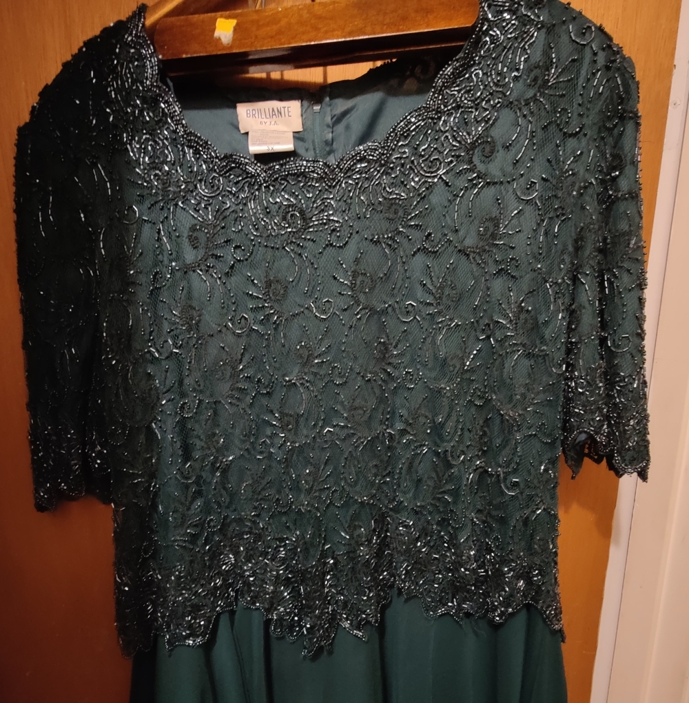 Dark green formal dress with a beaded and sequined bodice w a flowing skirt